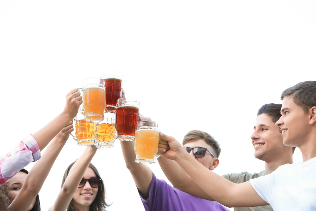 Friends cheersing beers in the air
