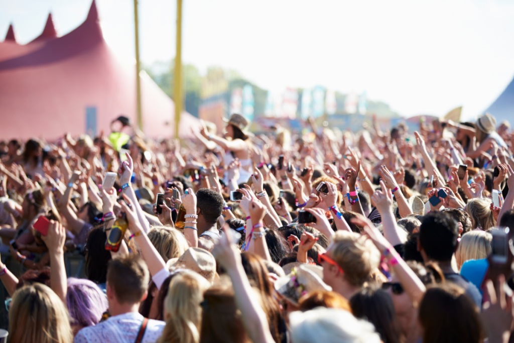 Crowd with hands raised at a music festival