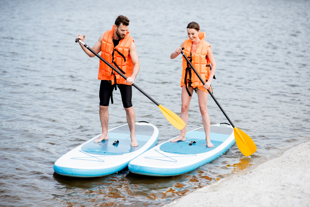 two people stand up paddle boarding